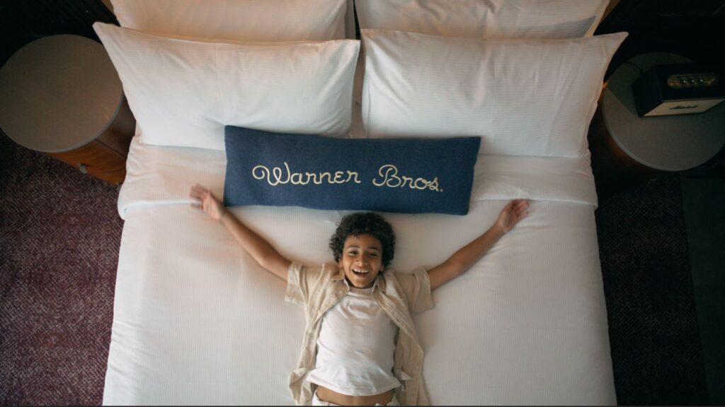 boy child laying down on hotel bed