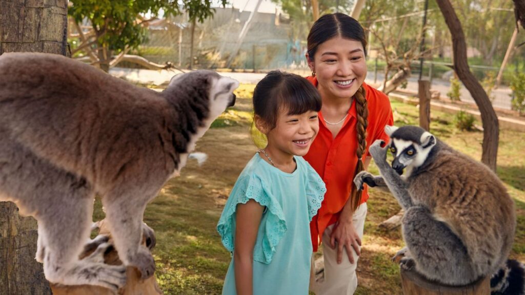 A mother and kid looking at animals