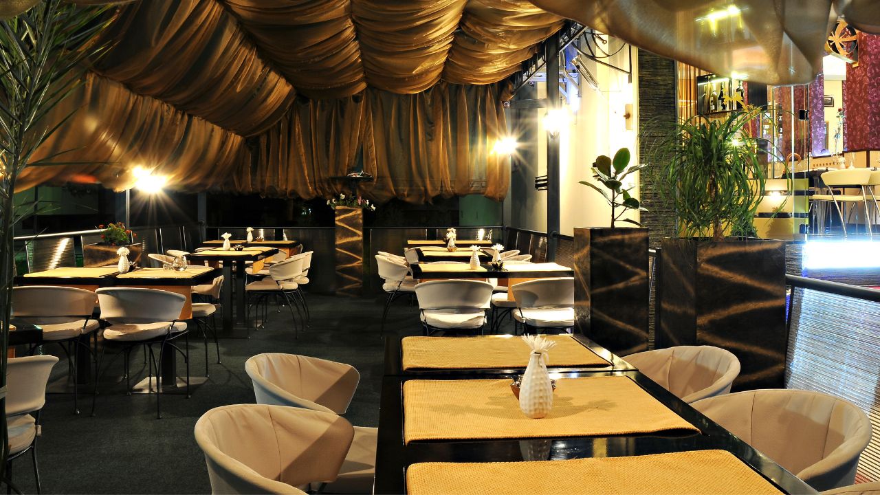 an empty dining area with tables and chairs neatly arranged