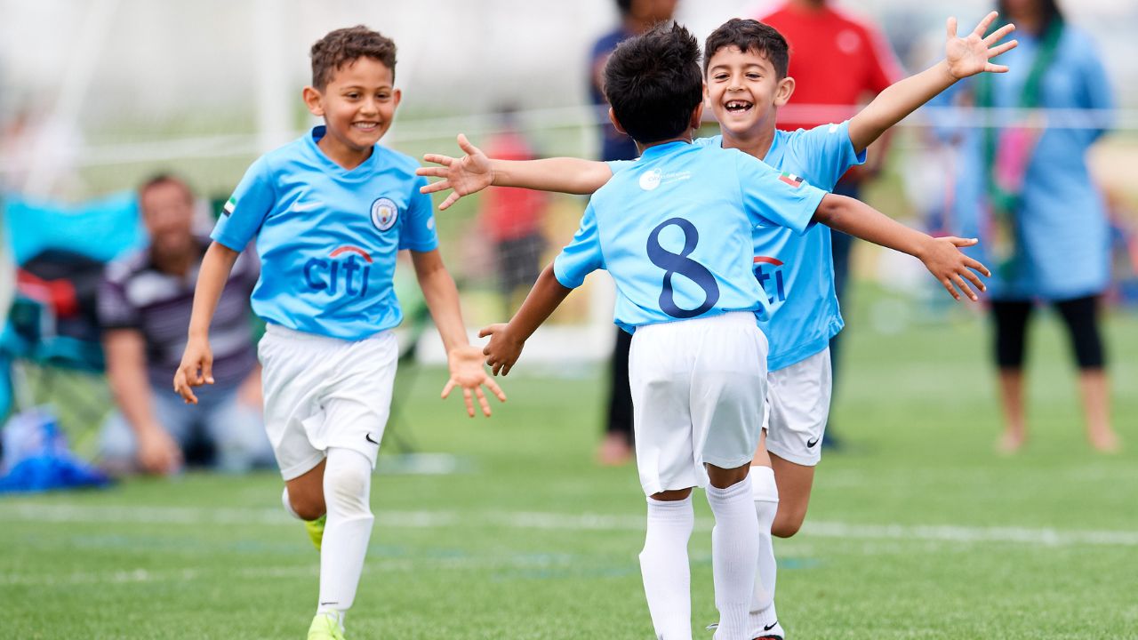 Children celebrating a football goal.
