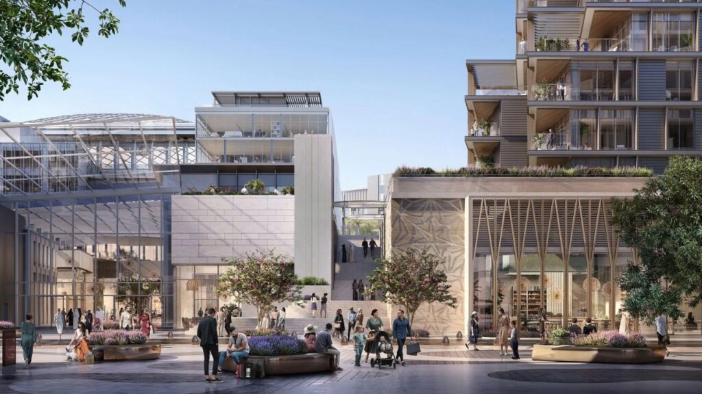 Modern shopping mall with landscaped areas.