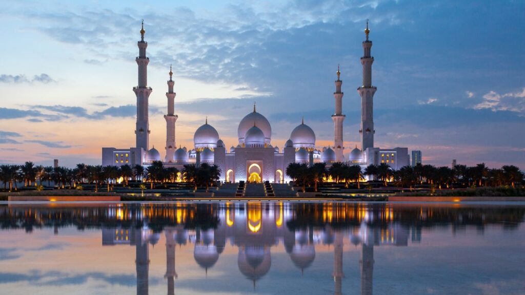 Majestic mosque reflecting in water.