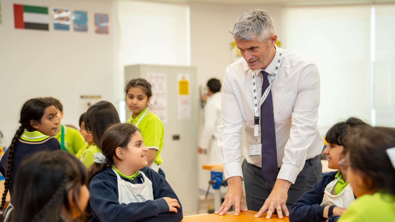 teacher talking to his students at mamoura british academy