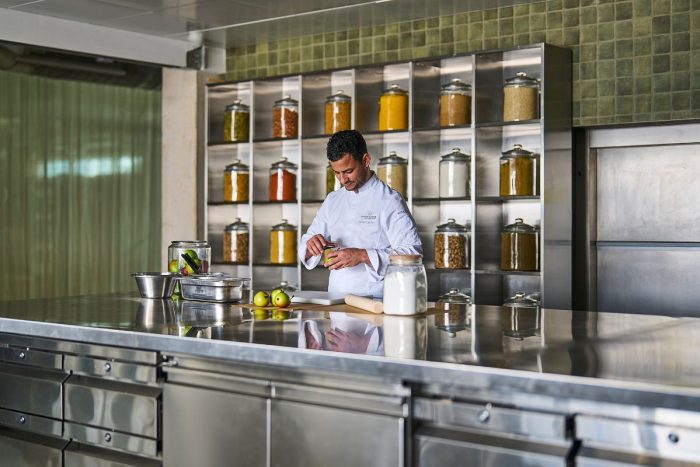 A chef preparing ingredients at Ecole ducasse cooking class