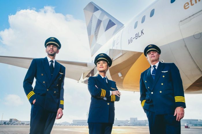 Etihad Airways pilots in front of an Etihad airplane