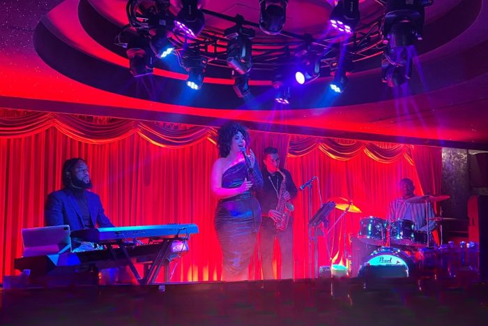 A lady singing on stage with a bad at Jazz Bar in Radisson Blu Abu Dhabi Corniche, things to do this weekend in Abu Dhabi