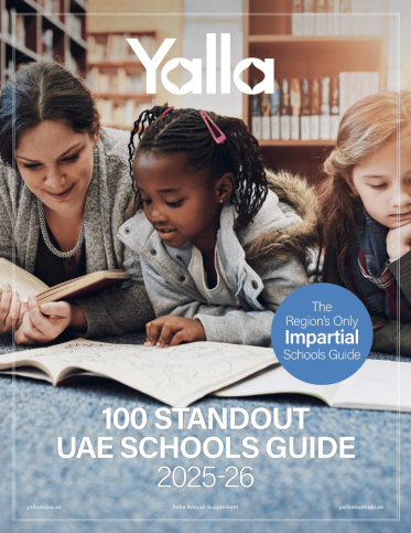 Cover of Yalla StandOut Schools guide edition 2 - with an adult and 2 kids laying on their tummies while reading in a library
