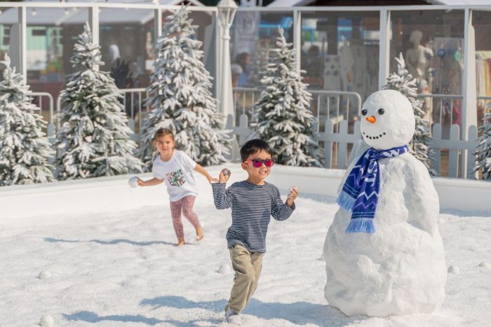 Children playing with snow at the Yas Winter Fest