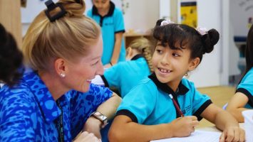 the british international school abu dhabi teacher smiling at student