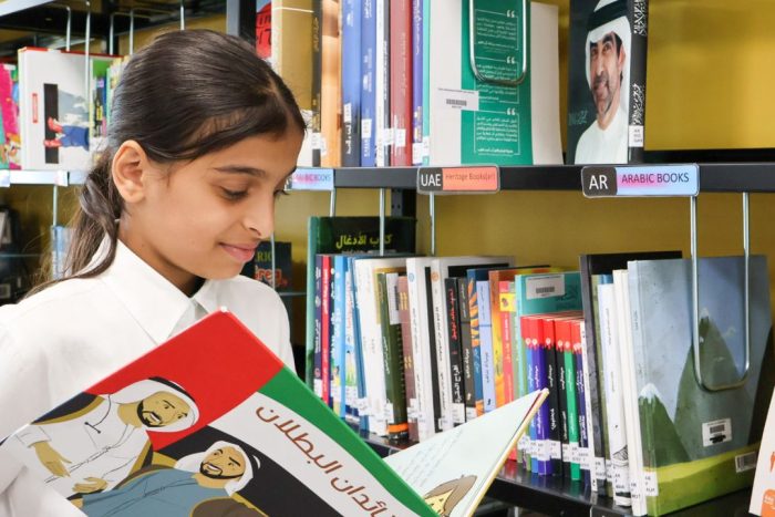 raha international school khalifa city campus student reading in the library