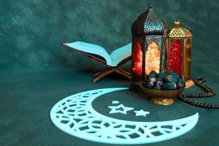 ramadan in abu dhabi featuring lantern, Quran, crescent moon and dates